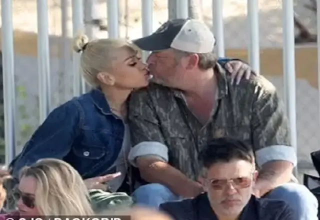 Gwen Stefani shares kiss with husband Blake Shelton while watching her sons football game